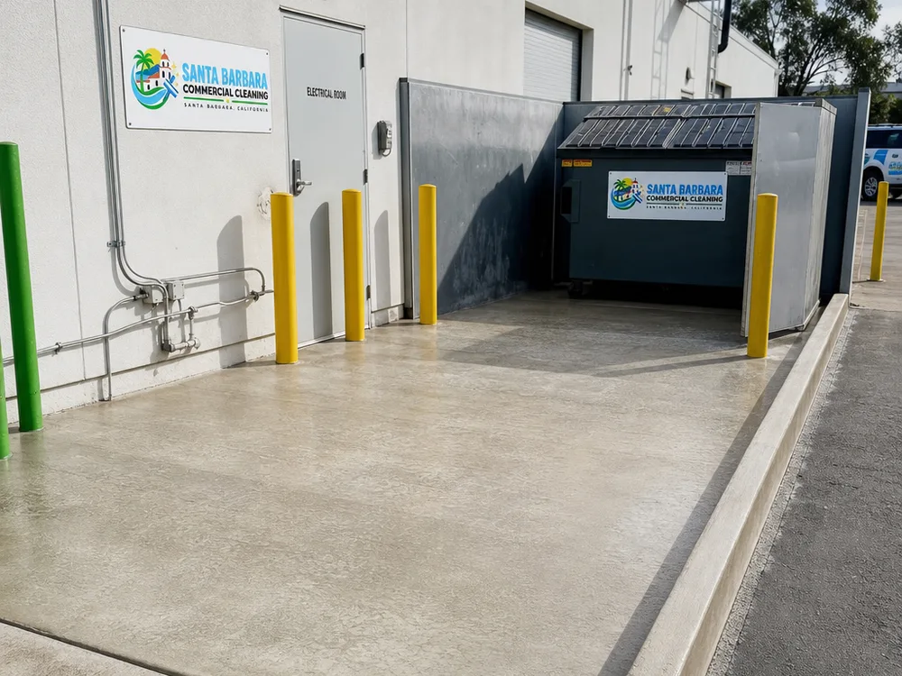 Commercial dumpster pad and surrounding concrete after pressure washing reduced stains and cleaned the edges